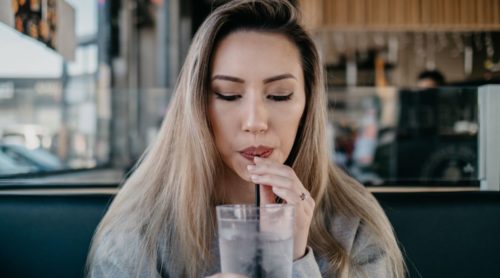 pretty woman drinking milkshake practising how to flirt with a guy